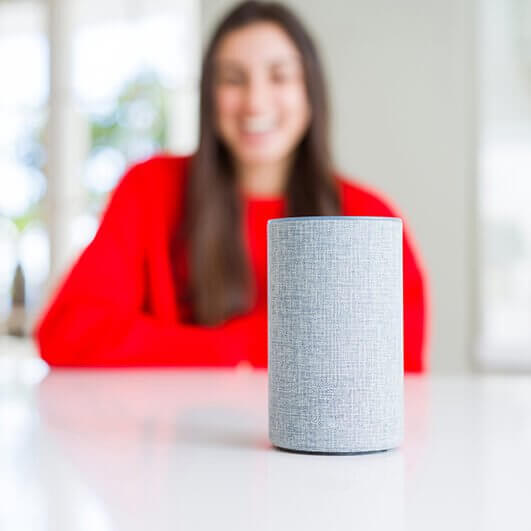 smart device in focus with woman speaking in the background