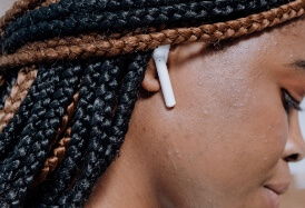 woman showing earbud in right ear