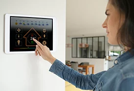 woman controlling devices in her home using a smart home system