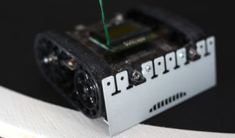 a black sumobot equipped with sensors as an example of domain-driven design in embedded systems