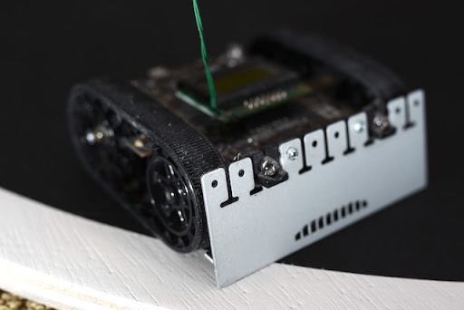 a black sumobot equipped with sensors as an example of domain-driven design in embedded systems