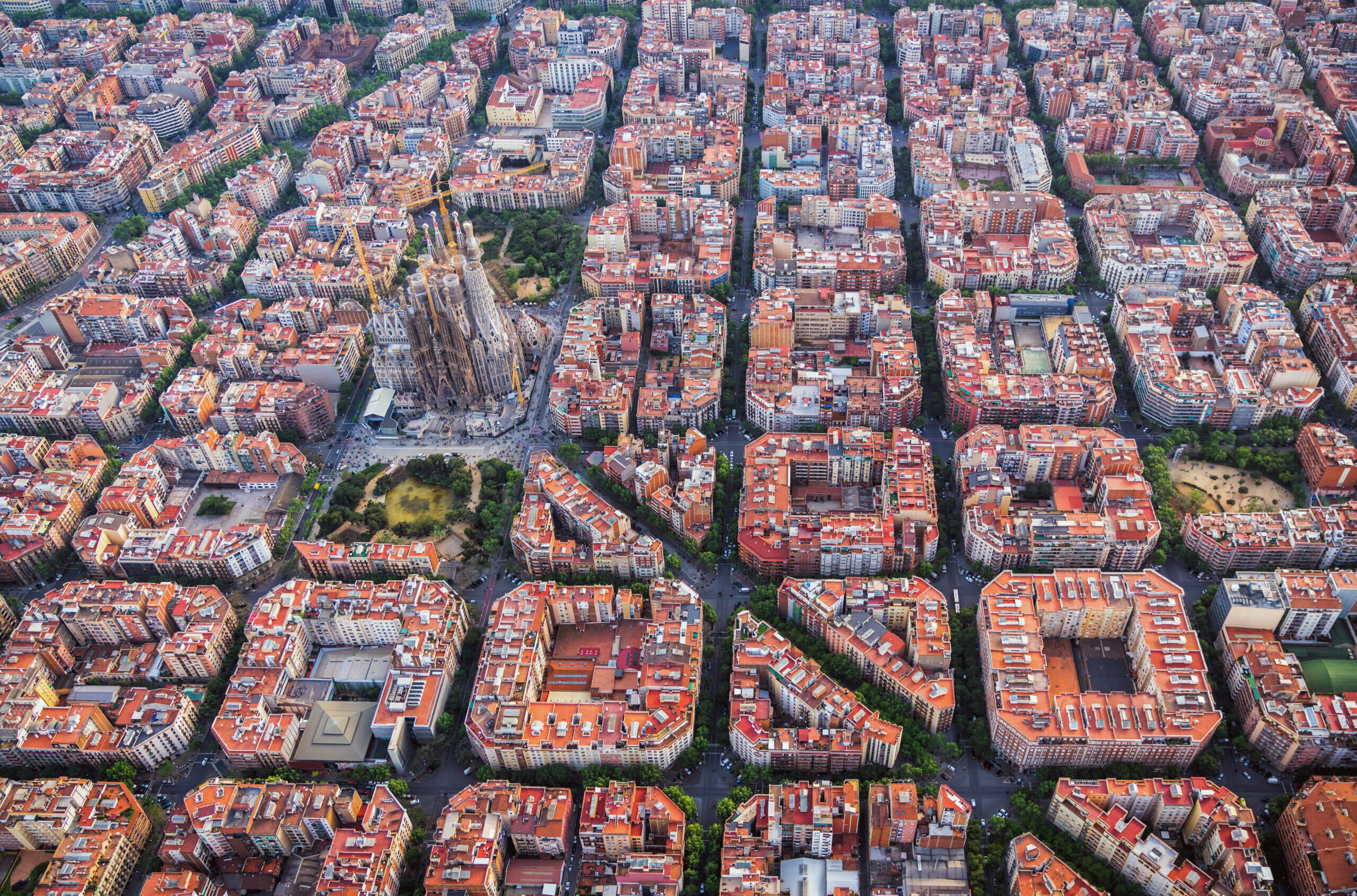 Aerial view of Barcelona Example residential district and Sagrada Familia, Spain. Late afternoon light